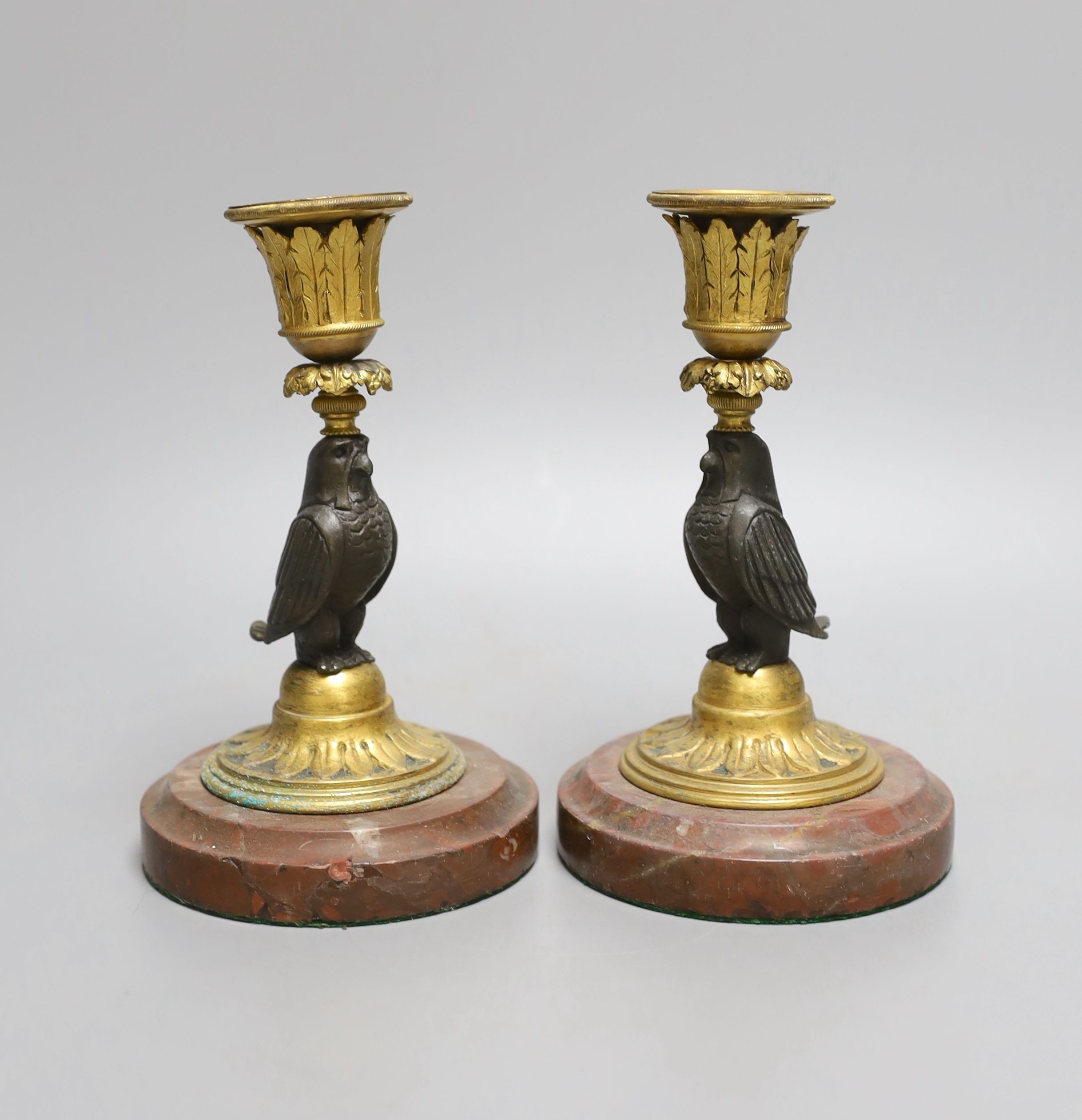 A pair of bronze and ormolu owl candlesticks - 16.5cm tall